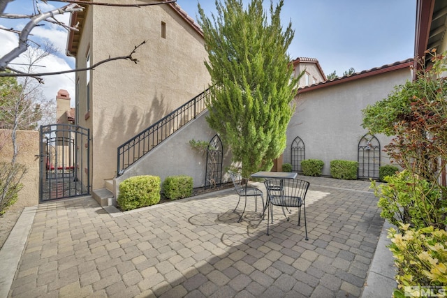 5140 Belsera Ct, Reno, NV 89519 - view of patio / terrace featuring a gate, outdoor dining area, fence, and stairway