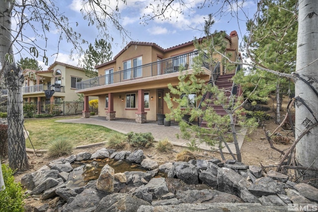 5140 Belsera Ct, Reno, NV 89519 - rear view of property with stucco siding, stairway, a patio, a tiled roof, and a wooden deck