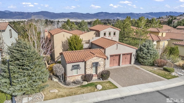 5140 Belsera Ct, Reno, NV 89519 - view of front of property with stone siding, a tile roof, stucco siding, and a mountain view