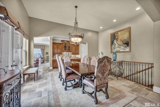 5140 Belsera Ct, Reno, NV 89519 - dining room with stone tile flooring, arched walkways, recessed lighting, a chandelier, and baseboards