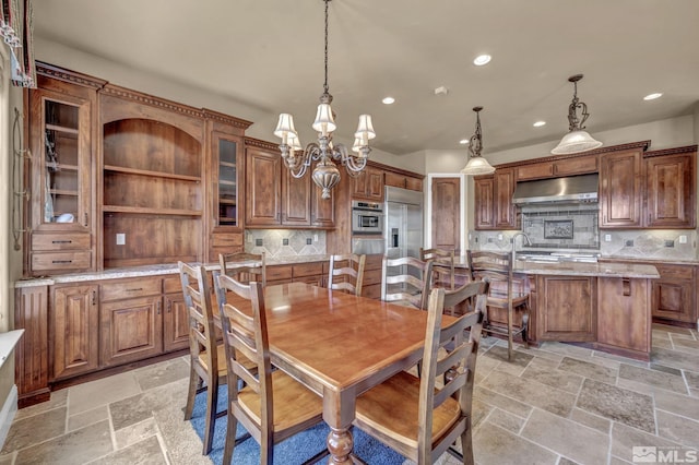 5140 Belsera Ct, Reno, NV 89519 - dining area featuring recessed lighting, a chandelier, and stone tile flooring
