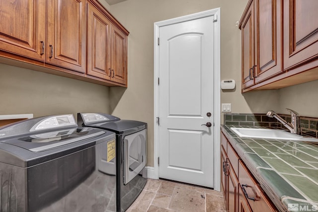 5140 Belsera Ct, Reno, NV 89519 - clothes washing area with cabinet space, washing machine and clothes dryer, and light stone finish floors