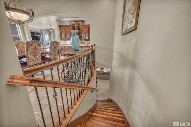 5140 Belsera Ct, Reno, NV 89519 - stairway with crown molding, arched walkways, and ceiling fan