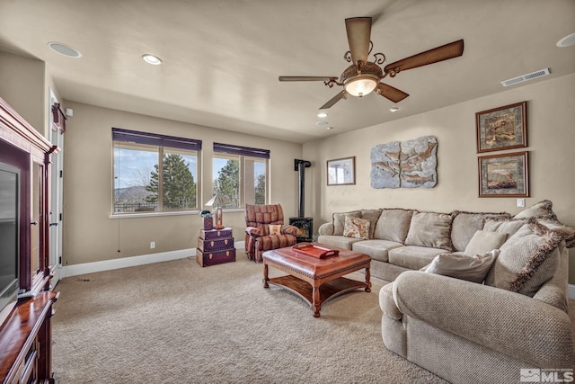 5140 Belsera Ct, Reno, NV 89519 - living room with a wood stove, ceiling fan, carpet flooring, baseboards, and recessed lighting