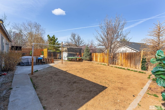 9745 Stone Vista Ct, Reno, NV 89506 - fenced backyard with a trampoline and a patio
