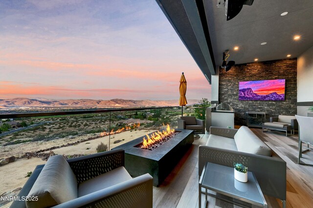 6372 Mormon Tea Way, Reno, NV 89511 - balcony at dusk with an outdoor living space with a fire pit and a mountain view