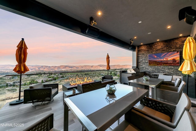 6372 Mormon Tea Way, Reno, NV 89511 - view of patio with an outdoor living space, a mountain view, outdoor dining area, and exterior kitchen