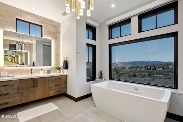 6372 Mormon Tea Way, Reno, NV 89511 - bathroom with a freestanding tub, vanity, and tile patterned floors