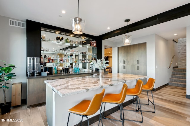 6372 Mormon Tea Way, Reno, NV 89511 - indoor wet bar featuring light wood-type flooring, hanging light fixtures, stairs, beamed ceiling, and recessed lighting