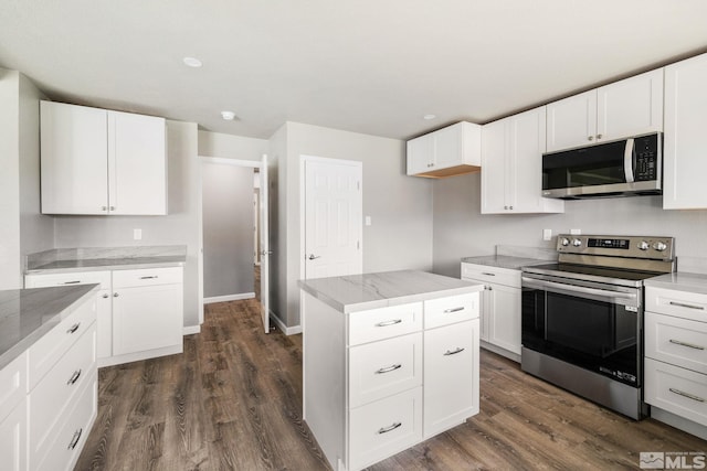 3390 Cashill Blvd, Reno, NV 89509 - kitchen featuring appliances with stainless steel finishes, dark wood-style floors, white cabinets, and light stone countertops