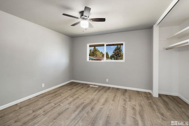 3390 Cashill Blvd, Reno, NV 89509 - unfurnished bedroom featuring light wood-style floors, baseboards, ceiling fan, a closet, and a textured ceiling