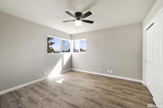 3390 Cashill Blvd, Reno, NV 89509 - unfurnished bedroom featuring baseboards, wood finished floors, a closet, and a ceiling fan