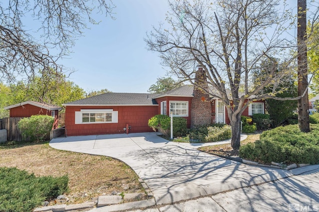 1100 Keystone Ave, Reno, NV 89503 - view of front facade with a chimney, roof with shingles, and fence