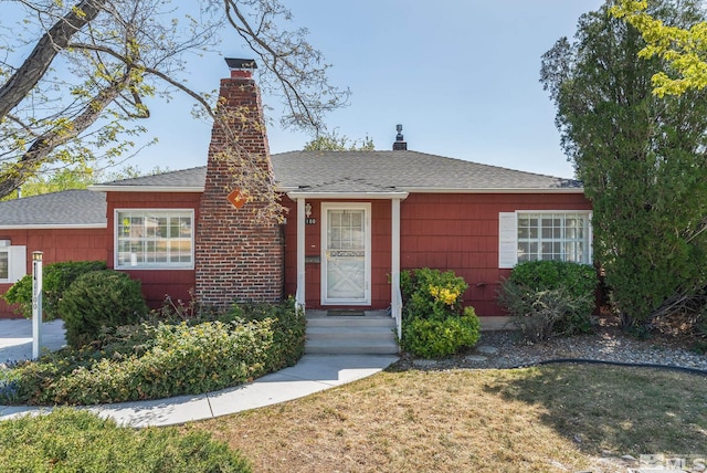 1100 Keystone Ave, Reno, NV 89503 - view of front of property with a chimney, a front lawn, and roof with shingles