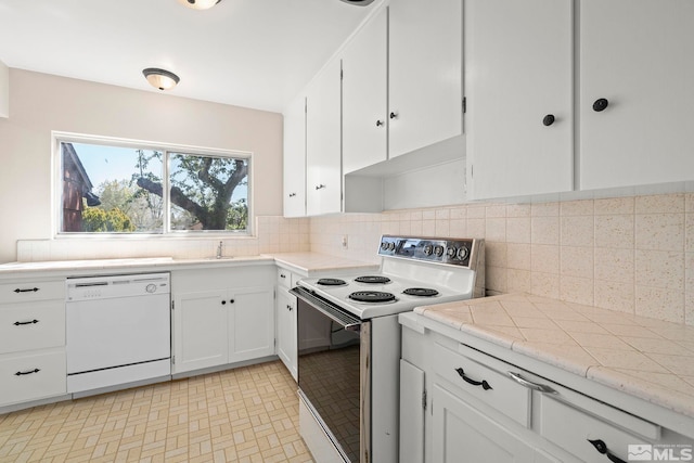 1100 Keystone Ave, Reno, NV 89503 - kitchen featuring white appliances, white cabinets, decorative backsplash, and light countertops