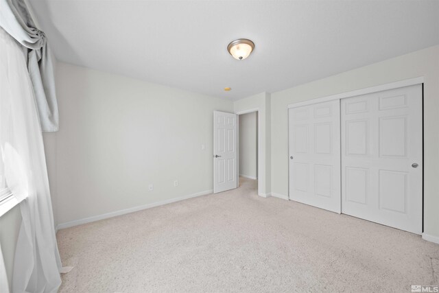 18305 Quarry Ct, Reno, NV 89508 - unfurnished bedroom with baseboards, carpet, and a closet