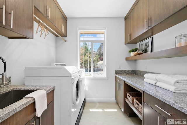 13000 Silver Wolf Rd, Reno, NV 89511 - laundry room featuring washing machine and clothes dryer, cabinet space, baseboards, and light tile patterned floors
