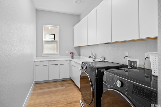 5424 Side Saddle Trl, Reno, NV 89511 - washroom with independent washer and dryer, cabinet space, a textured wall, baseboards, and light wood-style flooring