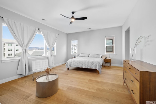 5424 Side Saddle Trl, Reno, NV 89511 - bedroom with multiple windows, light wood-style floors, and baseboards