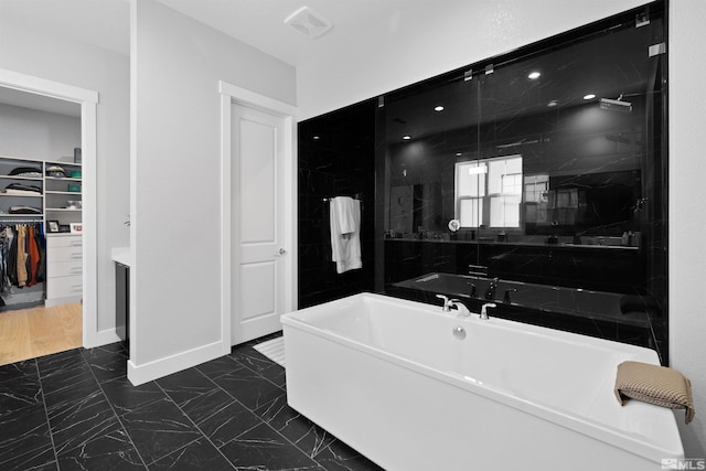 5424 Side Saddle Trl, Reno, NV 89511 - full bath featuring a freestanding tub, marble finish flooring, a walk in closet, and walk in shower
