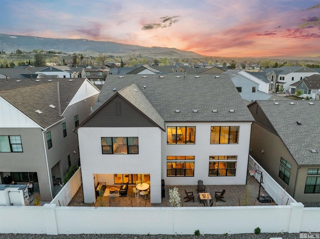 5424 Side Saddle Trl, Reno, NV 89511 - rear view of house with a fenced backyard, a residential view, a patio area, and stucco siding