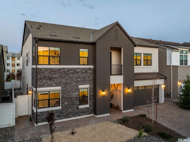 5424 Side Saddle Trl, Reno, NV 89511 - view of front of home with a garage, decorative driveway, stone siding, and fence