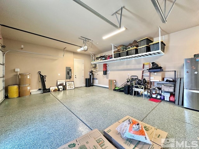 garage featuring freestanding refrigerator, electric panel, baseboards, and a garage door opener