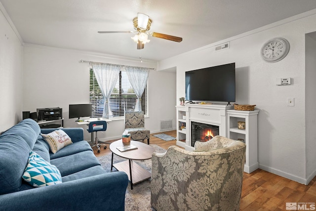 1465 E Peckham Ln Unit 9, Reno, NV 89502 - living area featuring ceiling fan, wood finished floors, a glass covered fireplace, baseboards, and crown molding