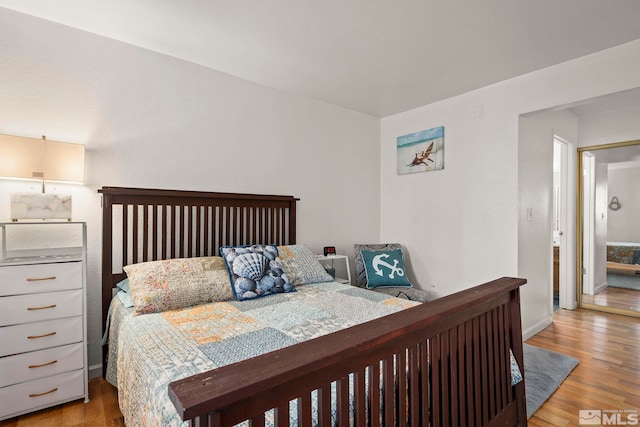1465 E Peckham Ln Unit 9, Reno, NV 89502 - bedroom featuring wood finished floors and baseboards
