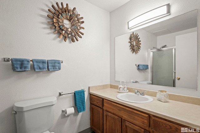 1465 E Peckham Ln Unit 9, Reno, NV 89502 - bathroom featuring toilet, a stall shower, and vanity