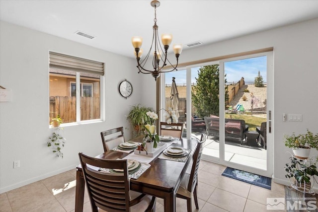 8555 Spearhead Way, Reno, NV 89506 - dining area with a chandelier, light tile patterned floors, and baseboards
