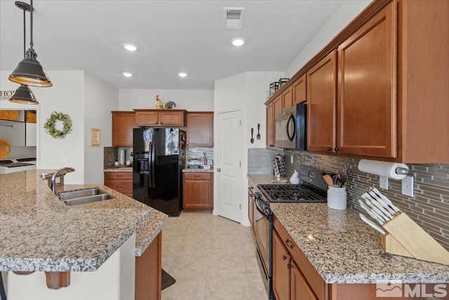 8555 Spearhead Way, Reno, NV 89506 - kitchen featuring black appliances, a sink, tasteful backsplash, brown cabinetry, and recessed lighting