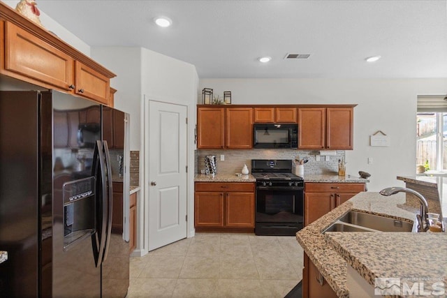 8555 Spearhead Way, Reno, NV 89506 - kitchen featuring black appliances, a sink, brown cabinets, backsplash, and recessed lighting