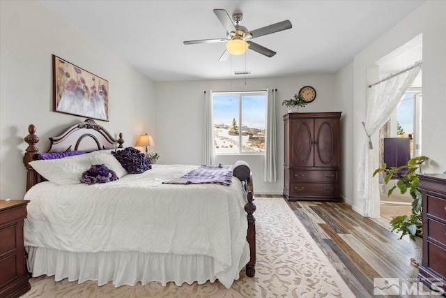 8555 Spearhead Way, Reno, NV 89506 - bedroom with light wood finished floors, a ceiling fan, and baseboards