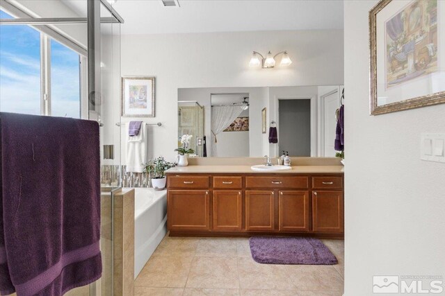 8555 Spearhead Way, Reno, NV 89506 - full bathroom featuring a stall shower, a garden tub, tile patterned flooring, vanity, and a ceiling fan