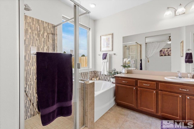 8555 Spearhead Way, Reno, NV 89506 - bathroom featuring a stall shower, tile patterned floors, a garden tub, vanity, and ceiling fan