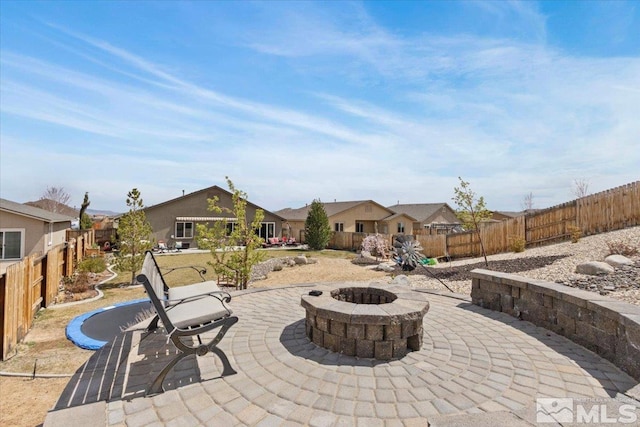 8555 Spearhead Way, Reno, NV 89506 - view of patio featuring an outdoor fire pit, a fenced backyard, and a residential view