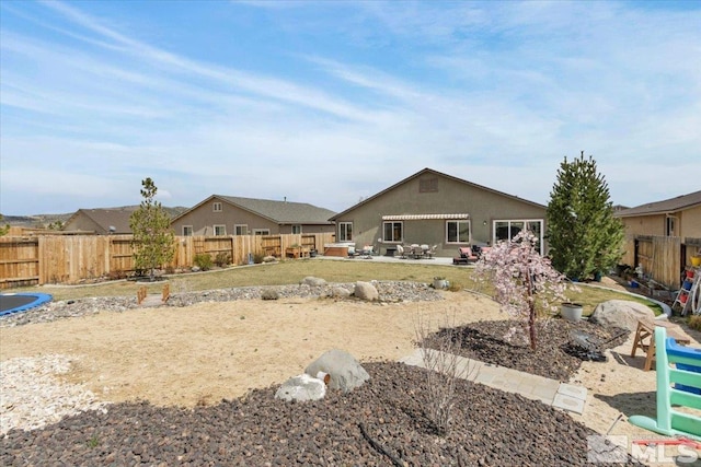 8555 Spearhead Way, Reno, NV 89506 - back of house with a patio area, a fenced backyard, and stucco siding