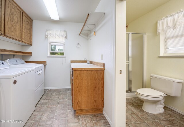 5375 Vinewood Cir, Fallon, NV 89406 - laundry room with washing machine and clothes dryer, baseboards, and brick patterned flooring