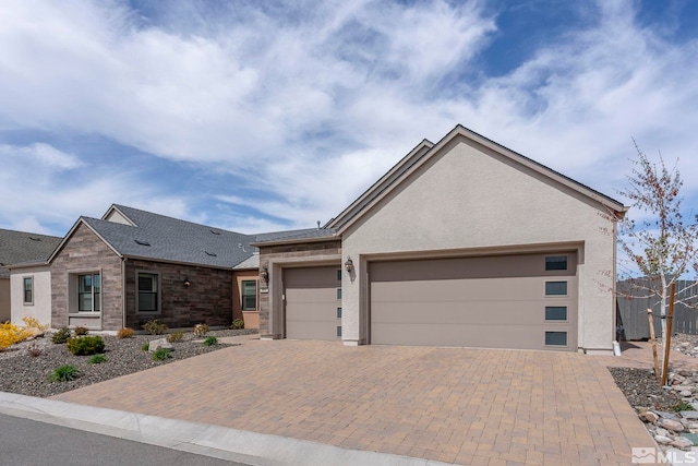 3019 Copper Stone Dr, Reno, NV 89521 - view of front of house featuring decorative driveway, a garage, roof with shingles, and stucco siding