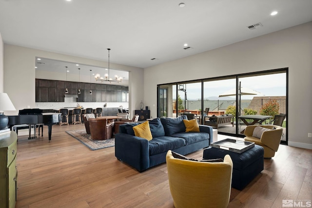 3019 Copper Stone Dr, Reno, NV 89521 - living area featuring light wood-style flooring, a chandelier, and recessed lighting