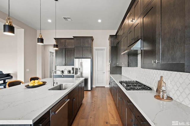 3019 Copper Stone Dr, Reno, NV 89521 - kitchen featuring a sink, appliances with stainless steel finishes, ventilation hood, dark brown cabinets, and hardwood / wood-style flooring