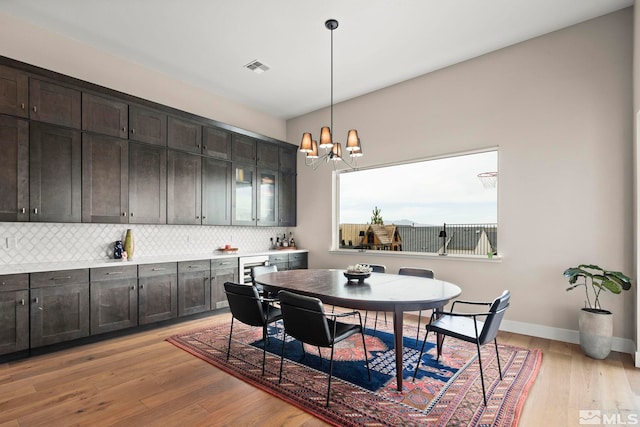 3019 Copper Stone Dr, Reno, NV 89521 - dining space featuring a chandelier, light wood-style flooring, and baseboards
