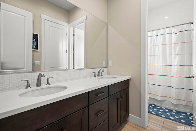 3019 Copper Stone Dr, Reno, NV 89521 - full bath with backsplash, double vanity, shower / bathtub combination with curtain, and baseboards