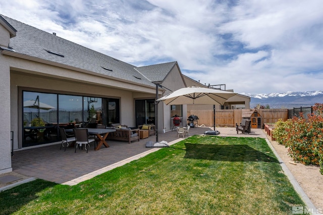 3019 Copper Stone Dr, Reno, NV 89521 - back of house with a patio, a mountain view, stucco siding, a shingled roof, and an outdoor hangout area