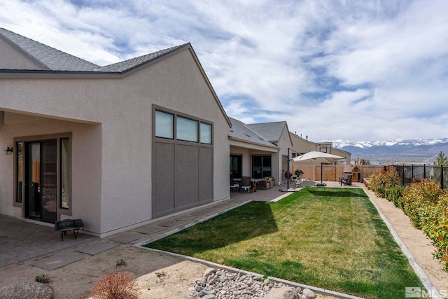 3019 Copper Stone Dr, Reno, NV 89521 - rear view of house featuring a patio area, stucco siding, a mountain view, and a shingled roof