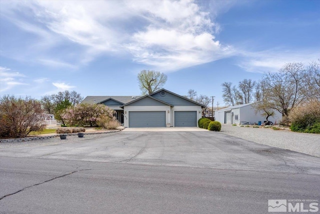 2875 Waegle Way, Fernley, NV 89408 - ranch-style home with a garage and driveway