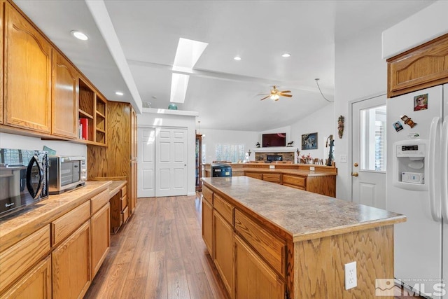 2875 Waegle Way, Fernley, NV 89408 - kitchen featuring white refrigerator with ice dispenser, a kitchen island, light wood-style flooring, a ceiling fan, and open floor plan