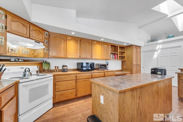 2875 Waegle Way, Fernley, NV 89408 - kitchen with electric stove, under cabinet range hood, vaulted ceiling, black microwave, and a kitchen island