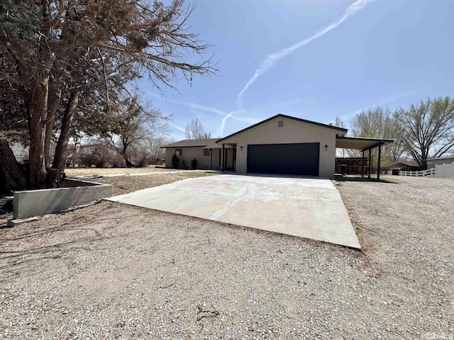 3003 Alcorn Rd, Fallon, NV 89406 - view of front of property featuring driveway, an attached garage, and stucco siding
